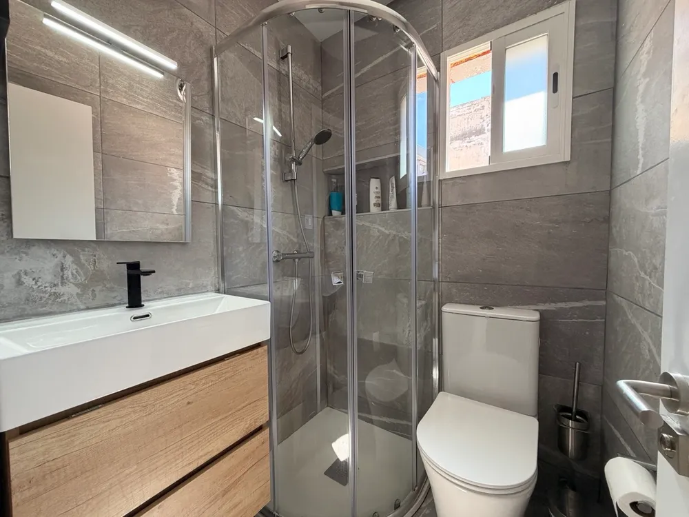 First bathroom at P21 Outpost - shower, blue sky, window, toilet