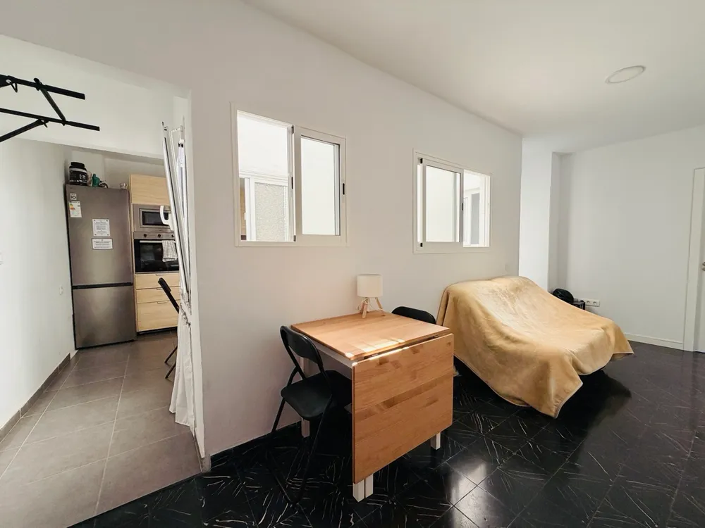 Hallway at P21 Outpost - sofa, dining table, pull-up bar, view into the kitchen