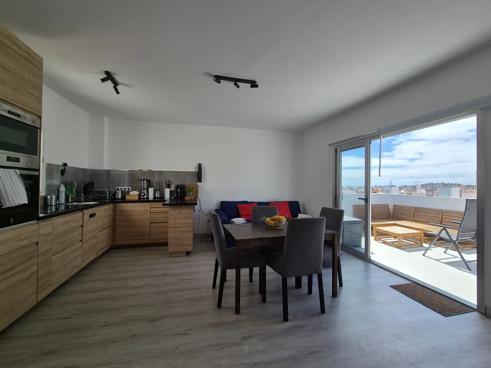 Kitchen and living room at J48 Penthouse - blue sky