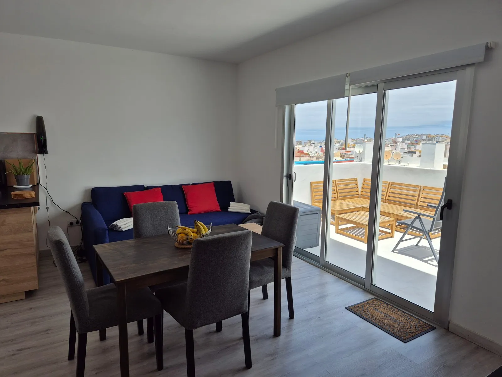 Kitchen and living room at J48 Penthouse - outdoor seating, blue sky