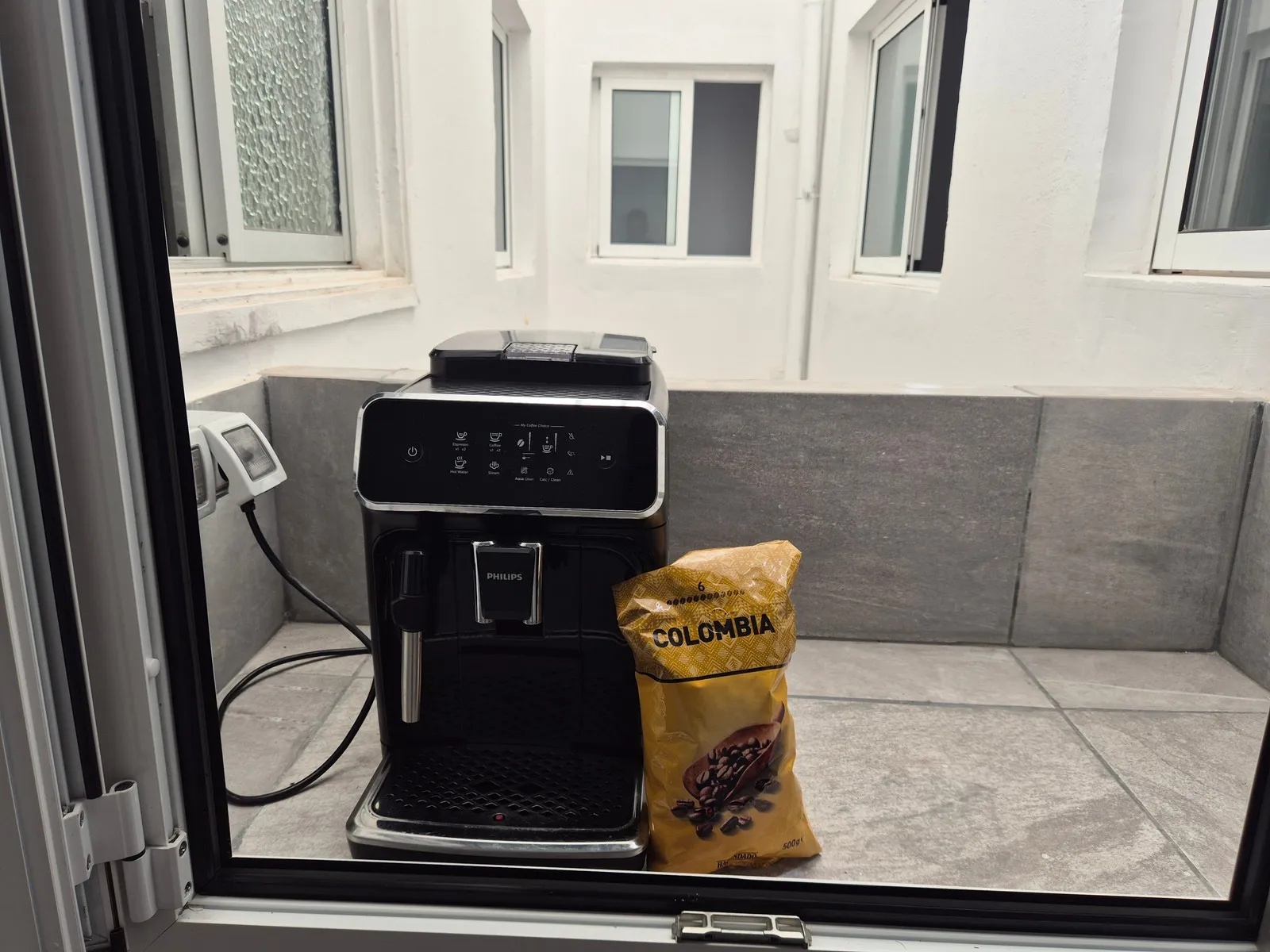 Pull-up coffee hallway at P21 Outpost - coffee machine, coffee beans, interior balcony