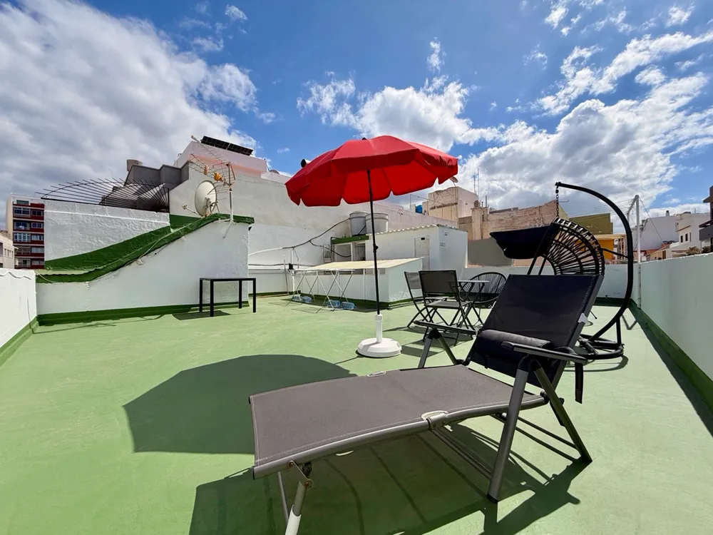 Sunbathing terrace at P21 Outpost - parasol, sunbed, hanging chair, blue sky